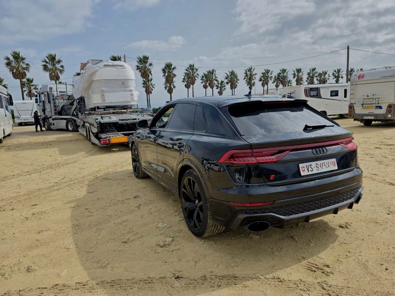 Recovered Audi RS Q8 beside a vehicle transporter on the Spanish coast